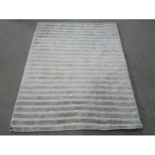 216 - A floor rug, measuring 120cm x 170cm.