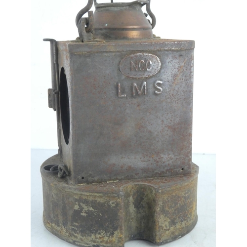 221 - An antique LMS railway lantern produced by Lamp Manufacturing & Railway Supplies Ltd, London.