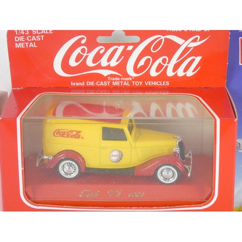 283 - Two boxed Coca Cola toy cars and another boxed Matchbox Thunderbirds plane.