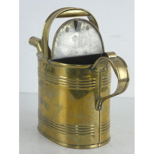 295 - A Victorian brass watering can, measuring 24cm high.