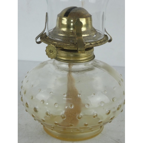 299 - A clear glass oil lamp.