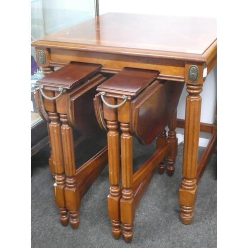 304 - An occasional table with two folding tables underneath with decorative metal work.