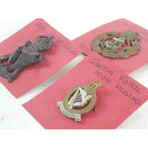 319 - Three vintage Army and Navy cap badges to include Royal Ulster Rifles, Queens Royal Irish Hussars an... 