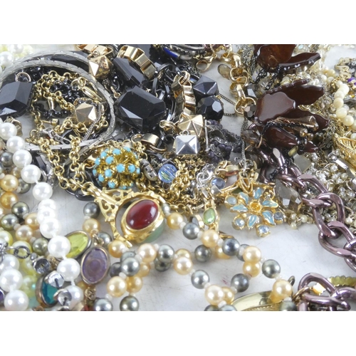 323 - A large lot of of assorted beaded necklaces, brooches etc.