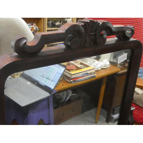 513 - An antique walnut dressing table mirror with scroll detail.