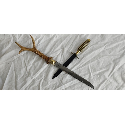 438 - An antique horn handle carving knife and a Manson Sheffield brass handled dagger.