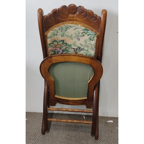 493 - An upholstered folding rocking chair.