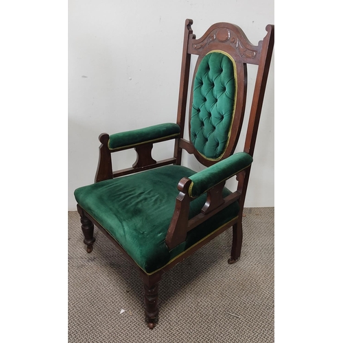 499 - An antique throne style button back armchair on castors.