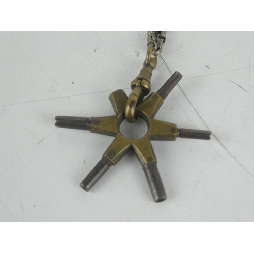 31 - A metal belcher chain and a pendant with clock keys.