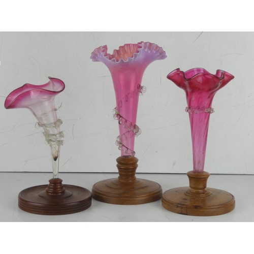 35 - Three antique ruby glass epergnes mounted on wooden stands.