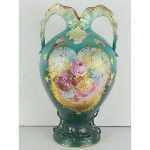 39 - An antique two handled vase decorated with a floral pattern.