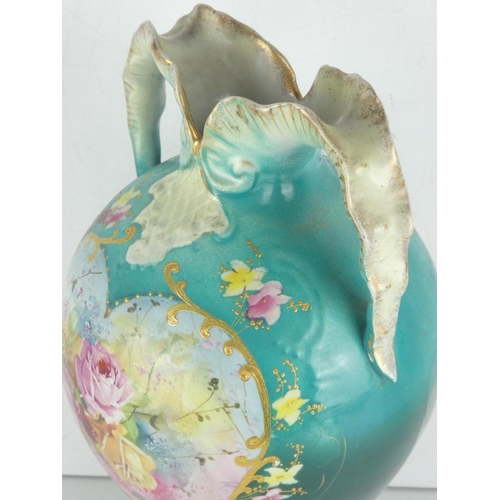 39 - An antique two handled vase decorated with a floral pattern.