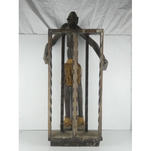 4 - An unusual wooden cd rack with carved figure.