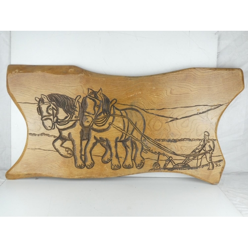 5 - A large carved oak panel of a horse and plough. Measuring 93cm x 47cm.