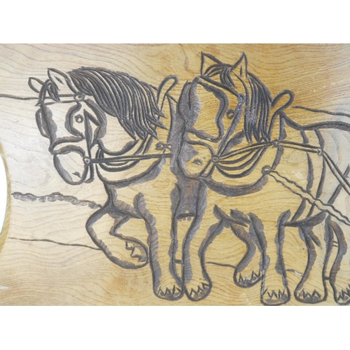 5 - A large carved oak panel of a horse and plough. Measuring 93cm x 47cm.