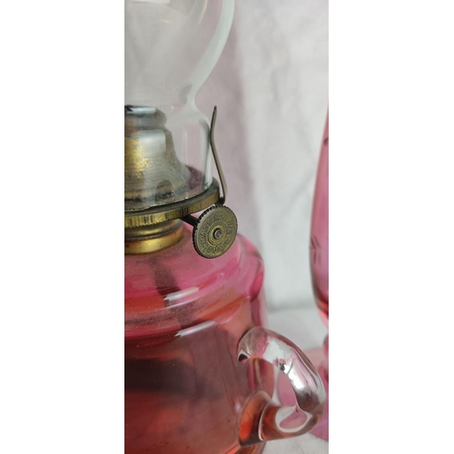 63 - An antique ruby glass finger lamp & vase.