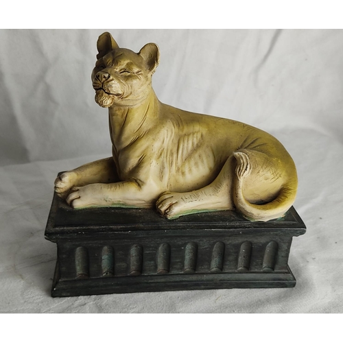 73 - A metal figure on a marble plinth and ornamental lion.