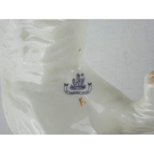 126 - Three Belleek pottery dogs.