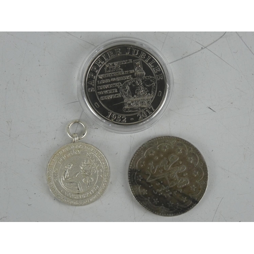 133 - A cased United Kingdom Commemorative Sapphire Jubilee £5.00 coin and two others,