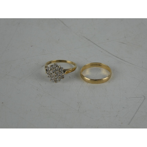 142 - A 9ct gold wedding band and 9ct gold dress ring. Weighing 3.5grams.