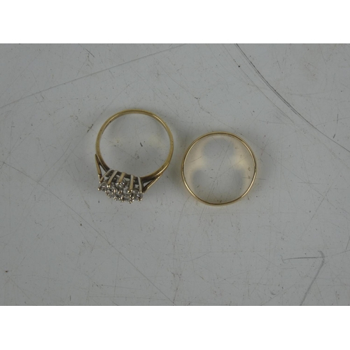 142 - A 9ct gold wedding band and 9ct gold dress ring. Weighing 3.5grams.