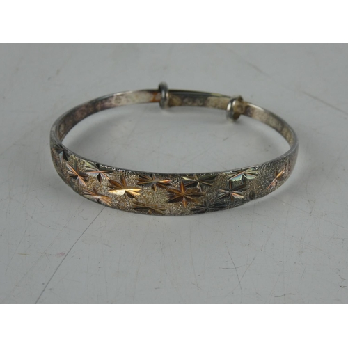 143 - A diamond cut silver plated bangle.