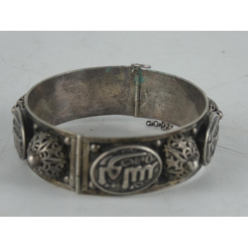 145 - A decorative Moroccan style white metal bangle.