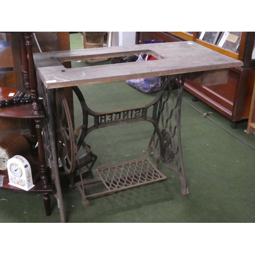 229 - An antique Singer Sewing machine table with cast iron base.