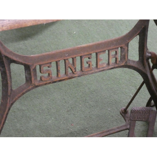 229 - An antique Singer Sewing machine table with cast iron base.