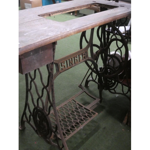 229 - An antique Singer Sewing machine table with cast iron base.