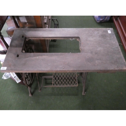 229 - An antique Singer Sewing machine table with cast iron base.