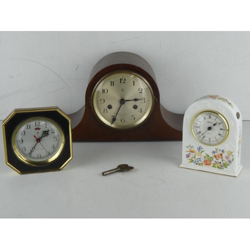 231 - A vintage wood cased mantle clock with scroll detail and two others.