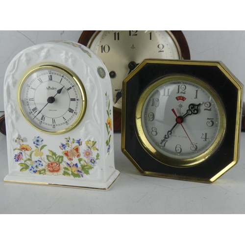 231 - A vintage wood cased mantle clock with scroll detail and two others.