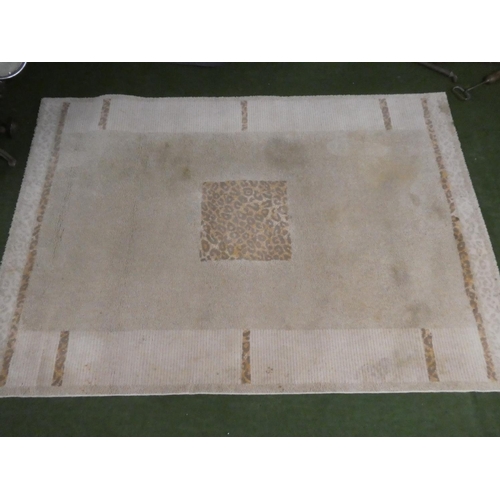 239 - A leopard print floor rug, measuring 195cm x 135cm.