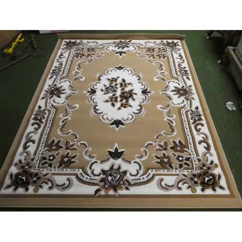 240 - A floral patterned floor rug, measuring 220cm x 160cm.