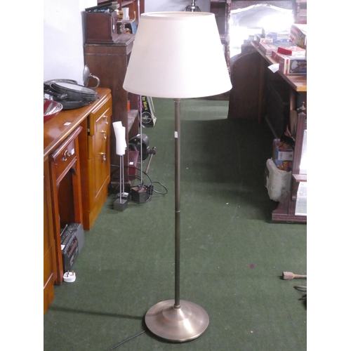 349 - A metal standard lamp with shade.