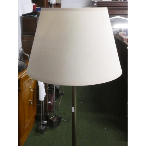 349 - A metal standard lamp with shade.