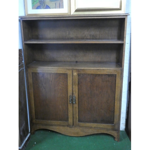 385 - An antique oak bookcase/ storage cabinet.