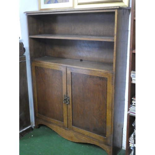 385 - An antique oak bookcase/ storage cabinet.