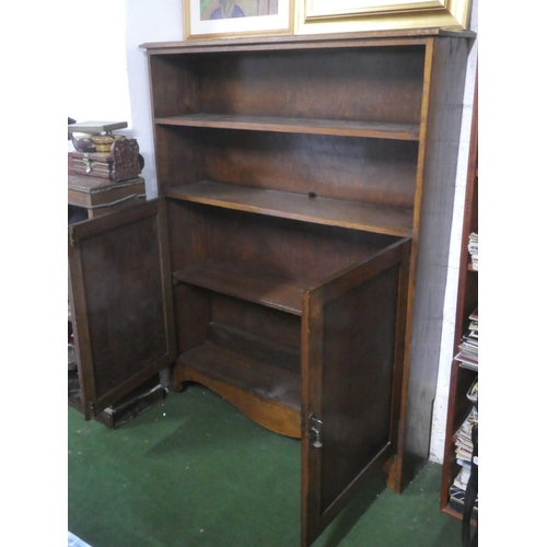 385 - An antique oak bookcase/ storage cabinet.