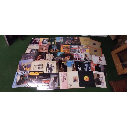 410 - A collection of records/ albums to include Wings, Fleetwood Mac & more.