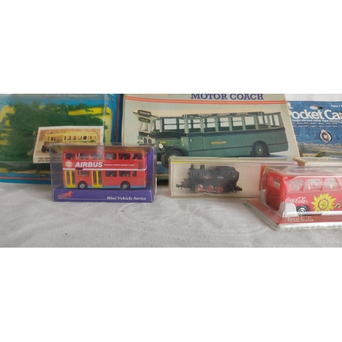 441 - A collection of model buses etc in original packaging.