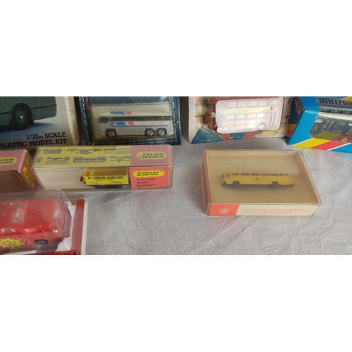 441 - A collection of model buses etc in original packaging.