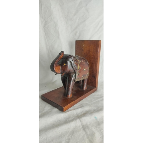 445 - A carved wooden elephant book end.