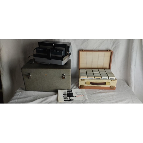 446 - A cased vintage slide projector & large assortment of slides.