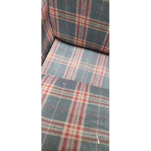 450 - A large wingback armchair with tartan upholstery.