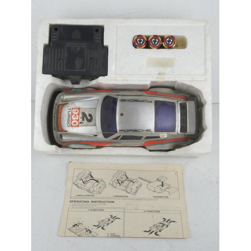 463 - A vintage boxed Radcon Porsche 930 Turbo radio controlled 1/15 sports car with instructions.