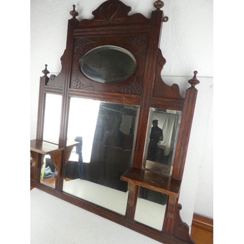 467 - An antique mahogany overmantle with bevelled glass mirror.