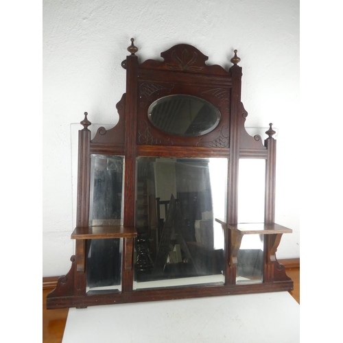 467 - An antique mahogany overmantle with bevelled glass mirror.