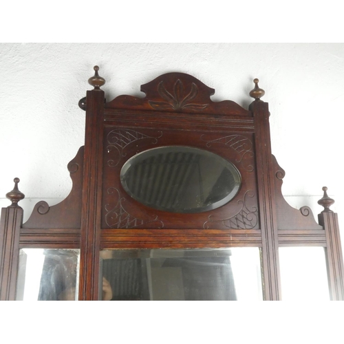 467 - An antique mahogany overmantle with bevelled glass mirror.